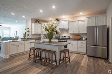 Sheffield Village apartment for rent - A kitchen with white cabinets and a wooden island.