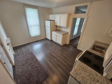 Lima house for rent - A kitchen with a refrigerator, oven, and cabinets.