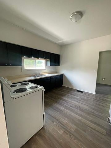 Lima house for rent - A white stove is in a kitchen with a window and black cabinets.