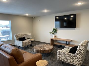 Sleepy Eye apartment for rent - a living room with couches and chairs and a tv