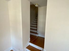 Omaha apartment for rent - A staircase with wooden steps and a white wall.