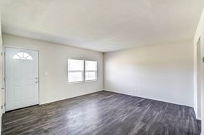 Lima apartment for rent - an empty living room with white walls and a white door