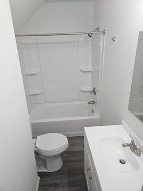 Lima house for rent - A white toilet sits next to a white sink in a small bathroom.