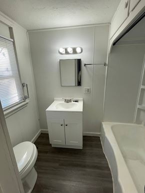 Lima house for rent - A white bathroom with a toilet, sink, and bathtub.