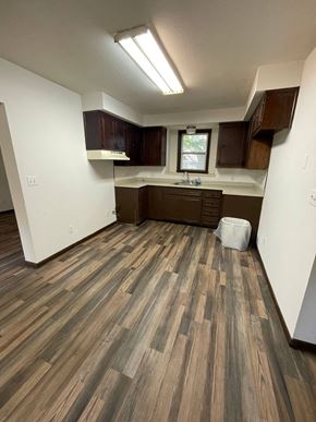 Lima house for rent - an empty kitchen with wood flooring in a new home