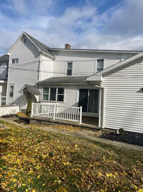 Cridersville apartment for rent - A house with a white porch and a brown roof.