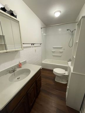 Cridersville apartment for rent - A white sink with a brown counter top and a white toilet in a bathroom.