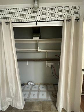 Cridersville apartment for rent - A bathroom with a white shower curtain and a white tile floor.