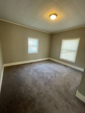 Cridersville apartment for rent - an empty room with two windows and a carpeted floor