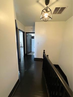 Baltimore apartment for rent - a hallway with a staircase and a hall way with a light and a door