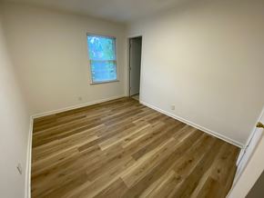 Louisville apartment for rent - A room with wooden flooring and a window.