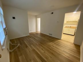 Louisville apartment for rent - A room with wooden flooring and white walls.