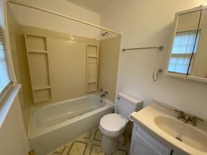 Louisville apartment for rent - A white bathroom with a toilet, sink, and bathtub.