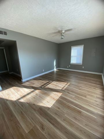 Shively apartment for rent - A room with wooden flooring and a ceiling fan.