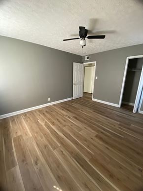 Shively apartment for rent - A room with a ceiling fan and wooden flooring.