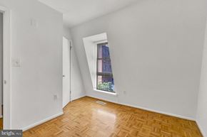 Washington apartment for rent - an empty room with a window and wooden floors