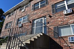 Lowell apartment for rent - a brick apartment building with stairs and a balcony