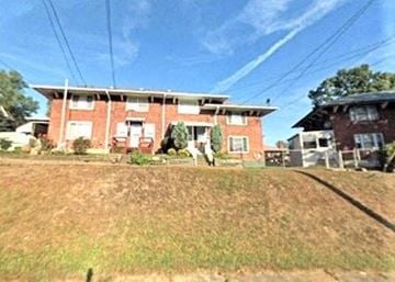 Clairton house for rent - a red brick house with a yard in front of it