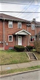 Clairton house for rent - A red brick house with a white door and windows.
