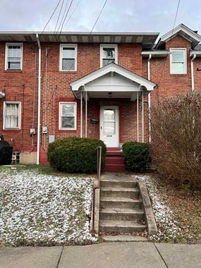 Clairton house for rent - A red brick house with a white door and windows.