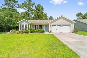 Richlands house for rent - A house with a garage and a driveway in front of it.
