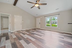 Richlands house for rent - A room with a ceiling fan and a window with a view of trees.