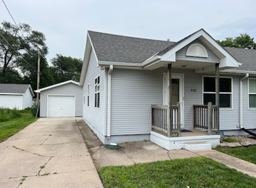 Fremont apartment for rent - A small house with a porch and a garage door.