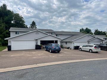 Menomonie apartment for rent - A house with a grey roof and a grey garage door.