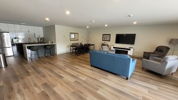 Bedford apartment for rent - A living room with a blue couch and a television.