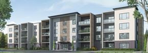 Bedford apartment for rent - A row of modern apartment buildings with balconies and trees in front.