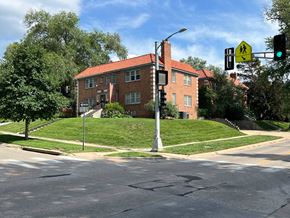 Omaha apartment for rent - an intersection with a green traffic light in front of a brick building