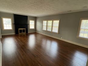 Omaha apartment for rent - an empty living room with wood floors and a fireplace