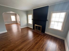 Omaha apartment for rent - a living room with a fireplace and a wooden floor