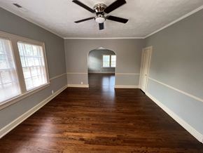 Omaha apartment for rent - a living room with wood floors and a ceiling fan
