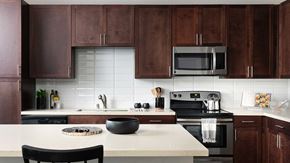 Austin apartment for rent - A kitchen with brown cabinets and stainless steel appliances.