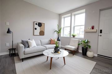 Philadelphia apartment for rent - A living room with a grey couch, a coffee table, and a painting on the wall.