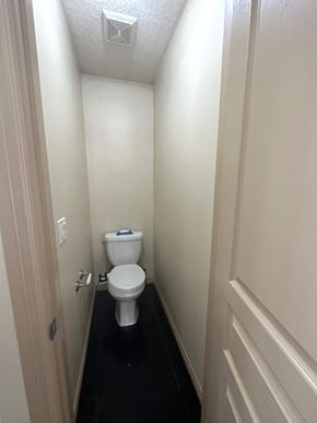 Calgary house for rent - a small bathroom with a toilet and a door
