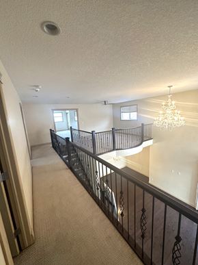 Calgary house for rent - the view from the top of the stairs into the living room and dining room