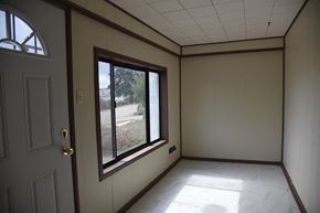 Trinidad house for rent - a living room with a large window and white walls
