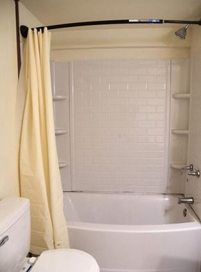 Trinidad house for rent - a bathroom with a tub and a toilet and a shower curtain