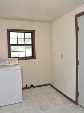 Trinidad house for rent - an empty kitchen with a white stove and a window
