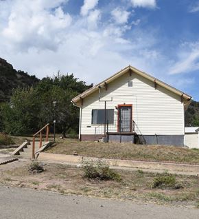 Trinidad house for rent - an old with a red door on the side of a road