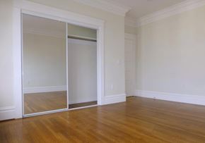 San Francisco apartment for rent - A room with a sliding door and wooden floors.
