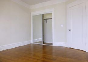 San Francisco apartment for rent - A room with a wooden floor and a white door.