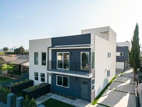 Los Angeles apartment for rent - a white and blue house with a balcony and a yard