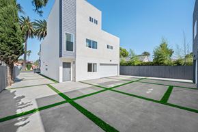 Los Angeles apartment for rent - a white house with a driveway and a yard with grass
