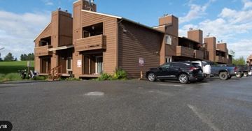 Anchorage apartment for rent - a building with cars parked in front of it