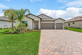 Estero house for rent - a house with a driveway and a garage door