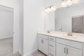 Estero house for rent - A bathroom with two sinks and a large mirror.