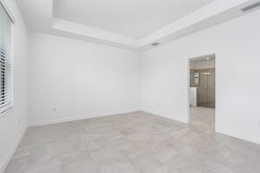 Estero house for rent - A spacious room with a tiled floor and a doorway leading to another room.